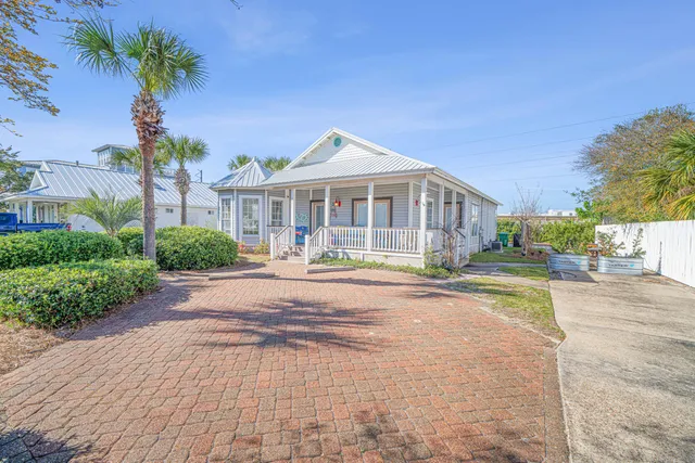 a kitchen with stainless steel appliances granite countertop a stove a sink dishwasher a refrigerator with a dining table and chairs