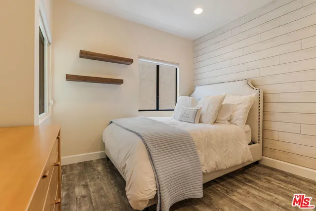 a bedroom with a bed and a night stand