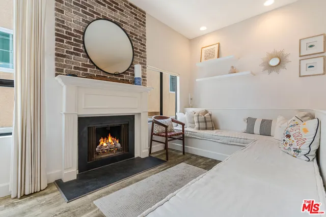 a living room with furniture a mirror and a fireplace