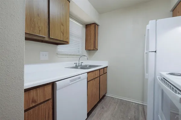 a kitchen with a sink a refrigerator and a stove