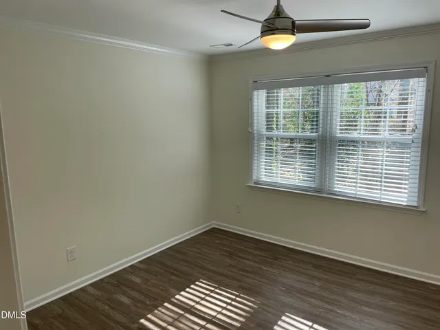 a bathroom with a granite countertop toilet sink and mirror