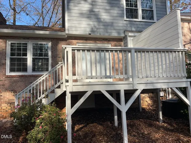 a view of balcony with wooden floor and fence
