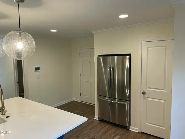 a view of a room with wooden floor