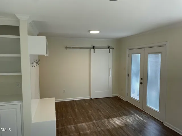 a view of walk in closet with wooden floor