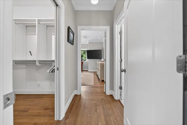 a spacious bedroom with a bed and a flat screen tv