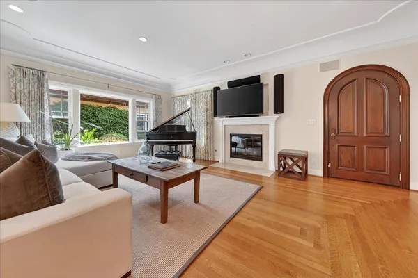 a living room with furniture a fireplace and a flat screen tv