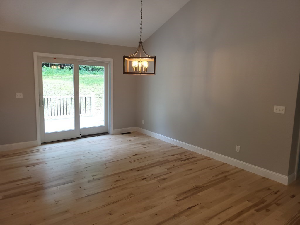 17 Harwood Farm Road Southbridge, MA 01550 - Photo 8 of 23 an empty room with wooden floor and windows
