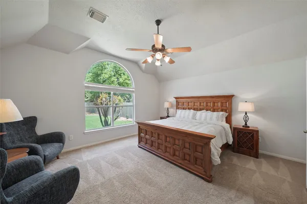 a bedroom with furniture and a window