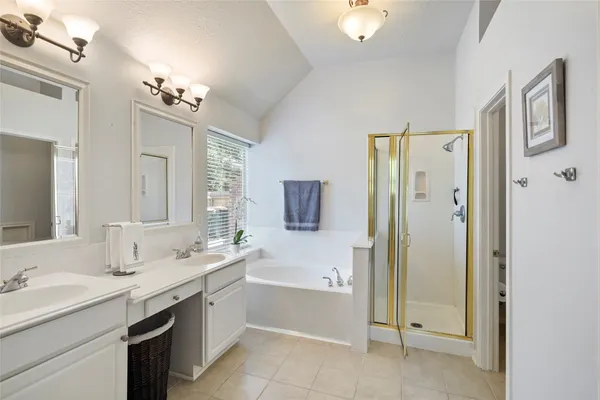 a bedroom with a bed window and a flat screen tv