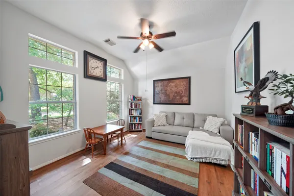 a living room with furniture and a book shelf