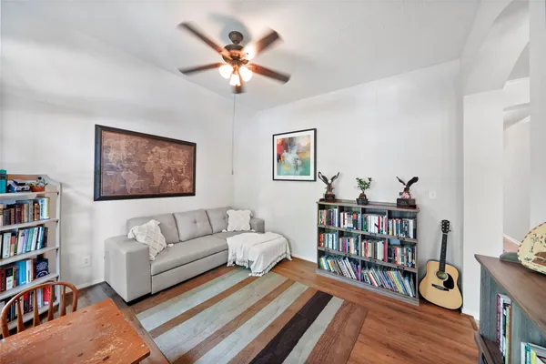 a living room with furniture a bookshelf and a book shelf