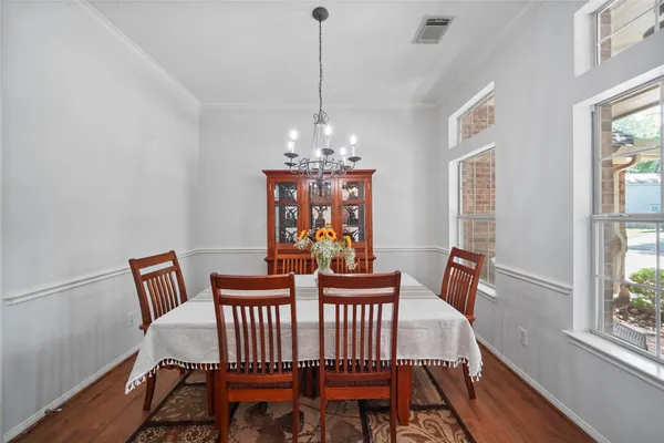 a view of a dining room with furniture wooden floor and a chandelier