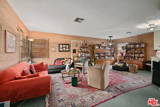 a living room with lots of furniture and clutter