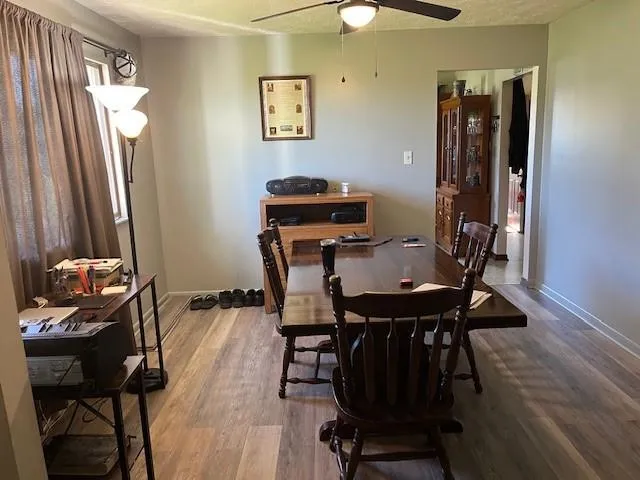a view of a workspace with furniture and wooden floor