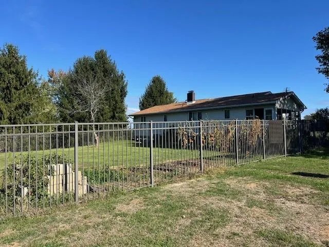 a view of a small yard and a wooden fence