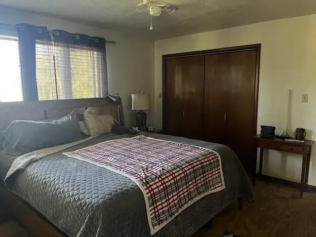 a bedroom with a bed and a window