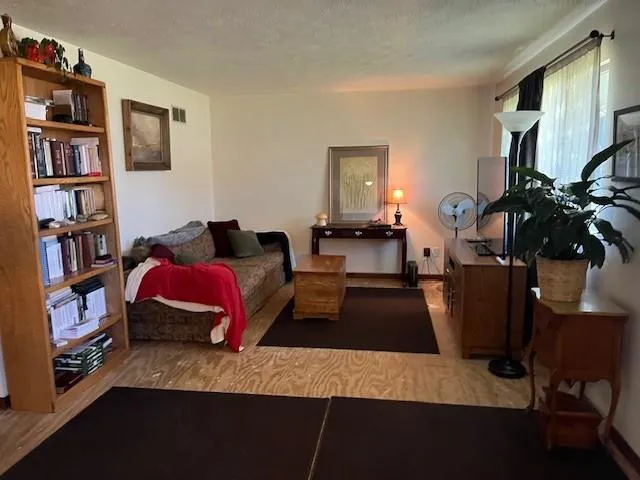 a living room with furniture and a book shelf