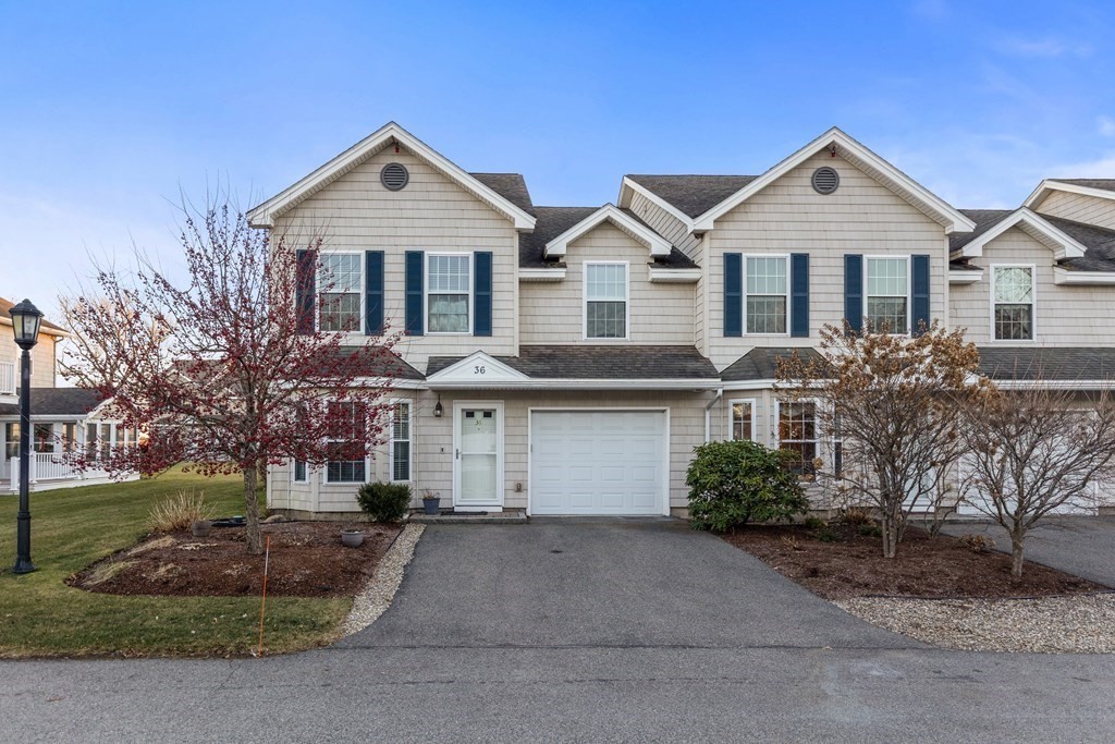 170 Beach Road, Unit 36 Salisbury, MA 01952 - Photo 1 of 40 a front view of a house with a yard and garage