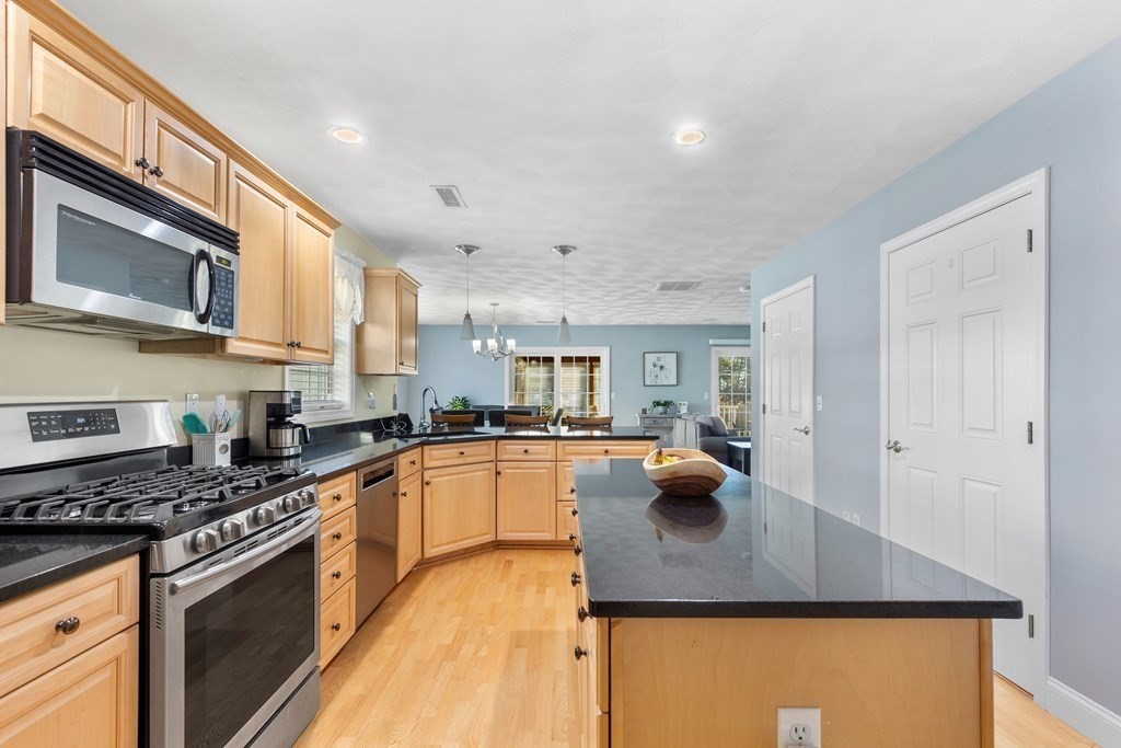 170 Beach Road, Unit 36 Salisbury, MA 01952 - Photo 3 of 40 a kitchen with stainless steel appliances granite countertop a stove a sink dishwasher a microwave oven with granite countertops and cabinets