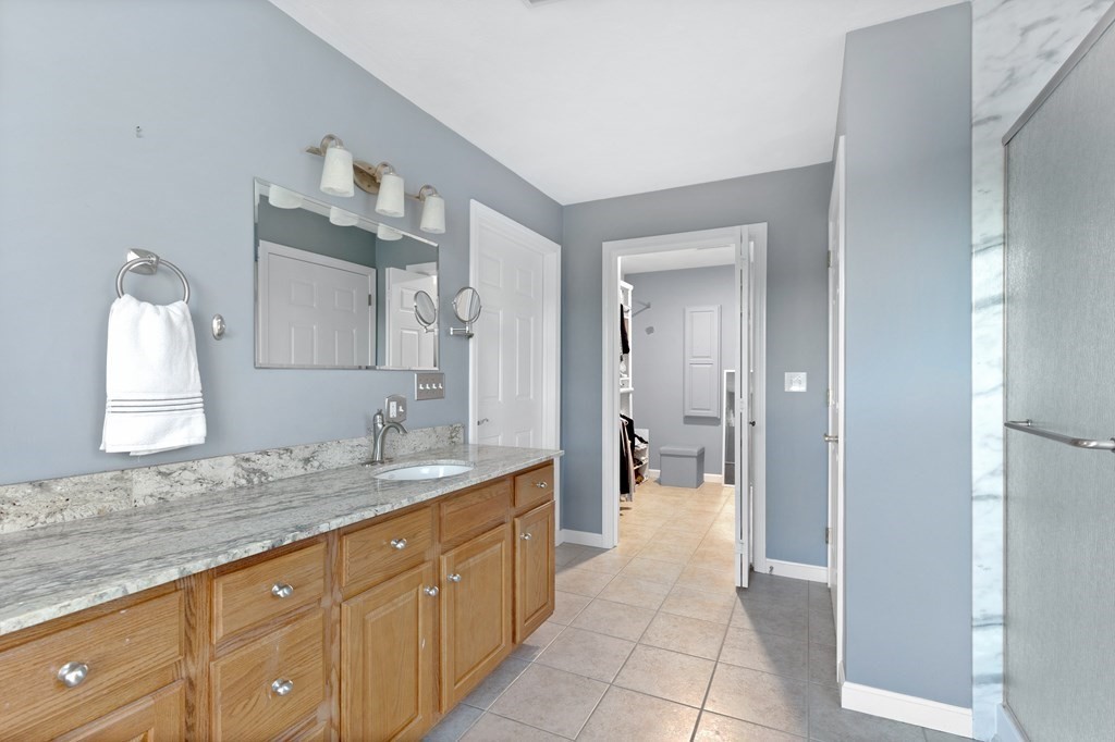 170 Beach Road, Unit 36 Salisbury, MA 01952 - Photo 33 of 40 a spacious bathroom with a granite countertop sink mirror and a