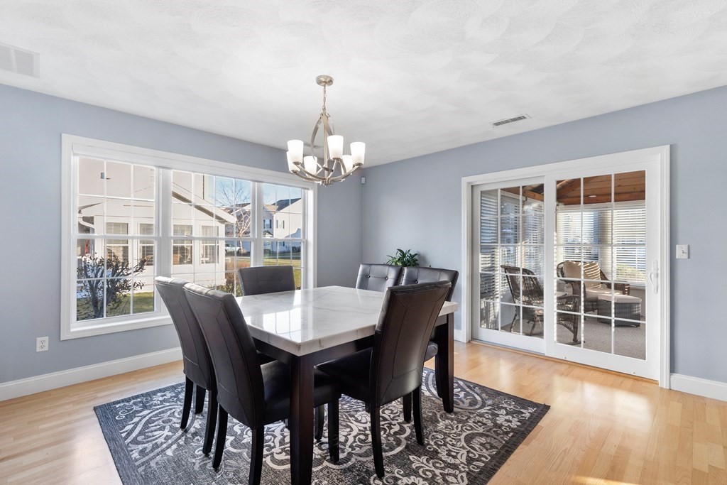 170 Beach Road, Unit 36 Salisbury, MA 01952 - Photo 9 of 40 a view of a dining room with furniture window and wooden floor