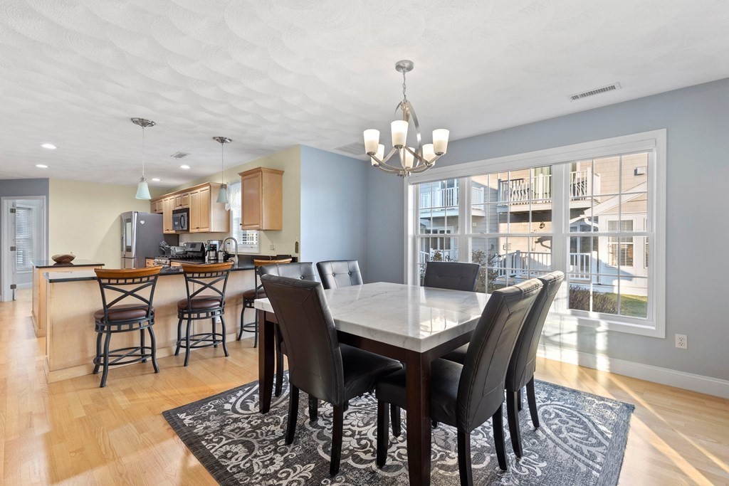 170 Beach Road, Unit 36 Salisbury, MA 01952 - Photo 10 of 40 a view of a dining room with furniture and wooden floor