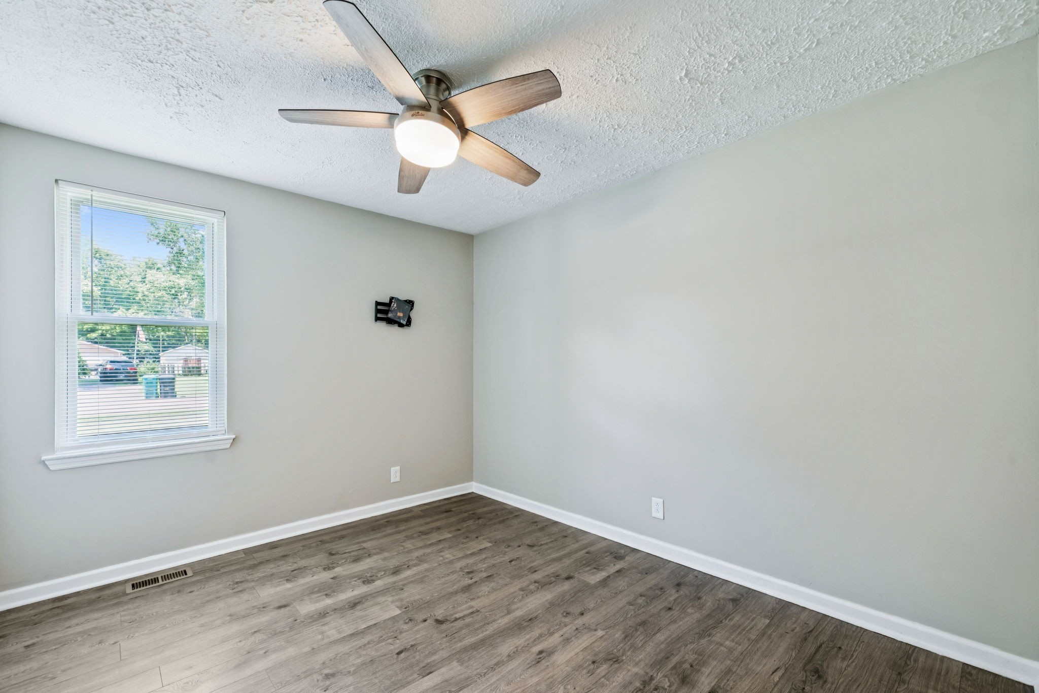 8124 Cooper Drive Murfreesboro, TN 37129 - Photo 12 of 19 an empty room with wooden floor fan and windows