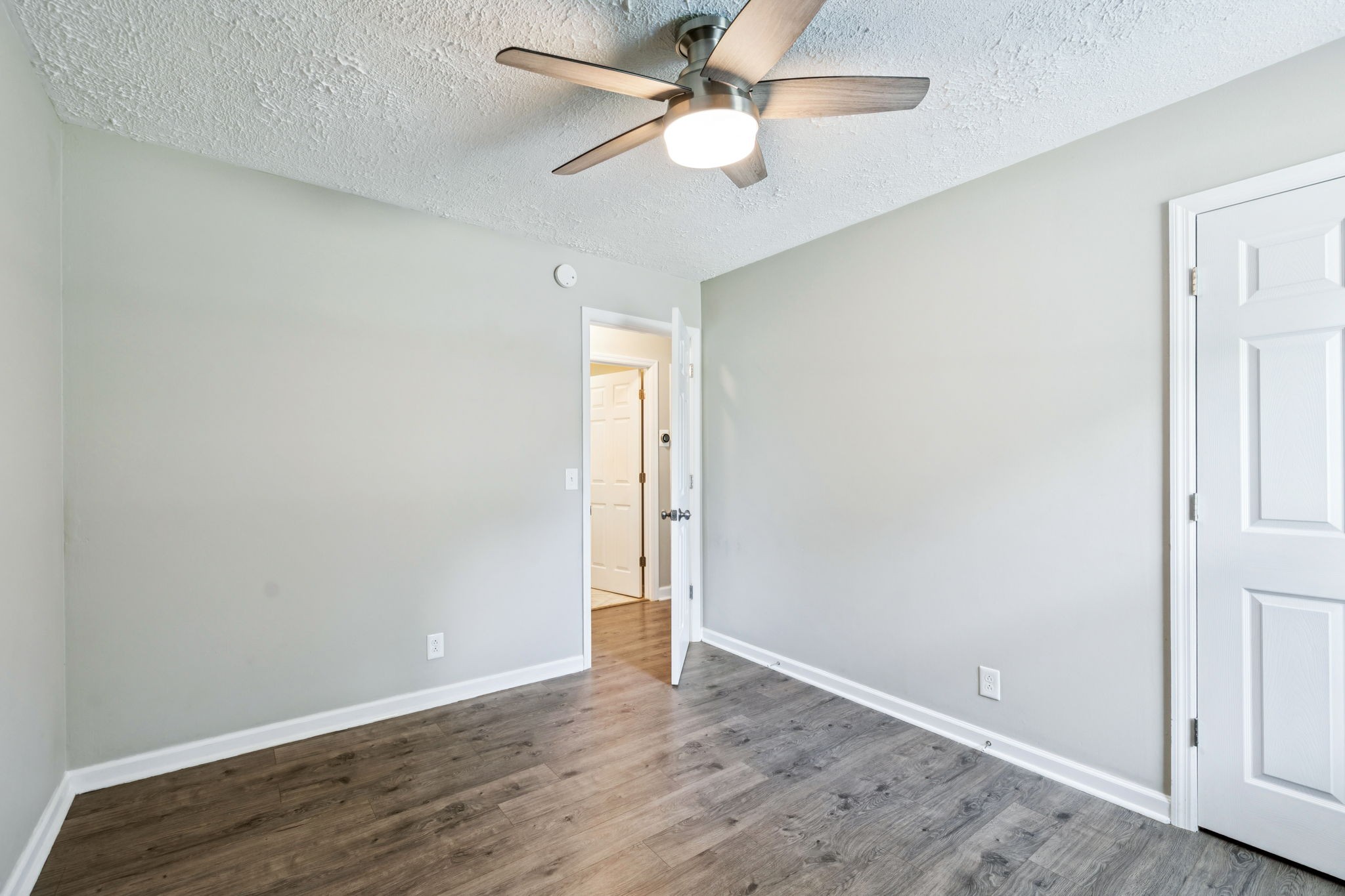 8124 Cooper Drive Murfreesboro, TN 37129 - Photo 13 of 19 an empty room with wooden floor fan and ceiling fan