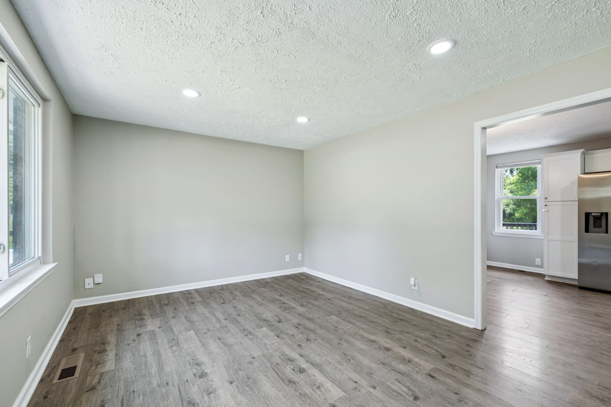 8124 Cooper Drive Murfreesboro, TN 37129 - Photo 6 of 19 an empty room with wooden floor and windows