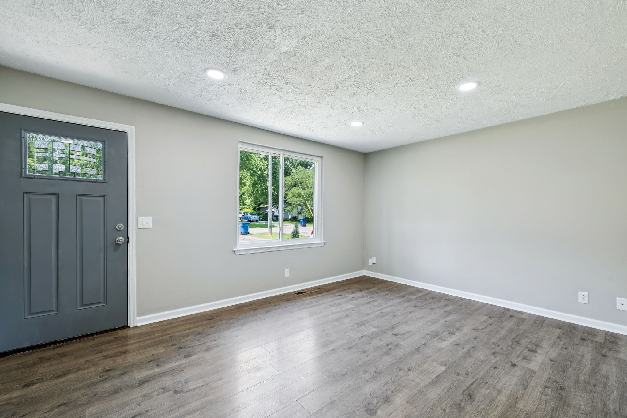 8124 Cooper Drive Murfreesboro, TN 37129 - Photo 7 of 19 an empty room with wooden floor and windows