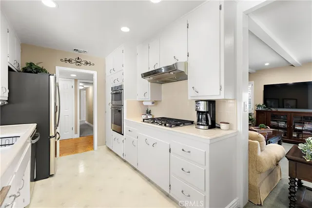 a kitchen with stainless steel appliances a stove a refrigerator and a sink