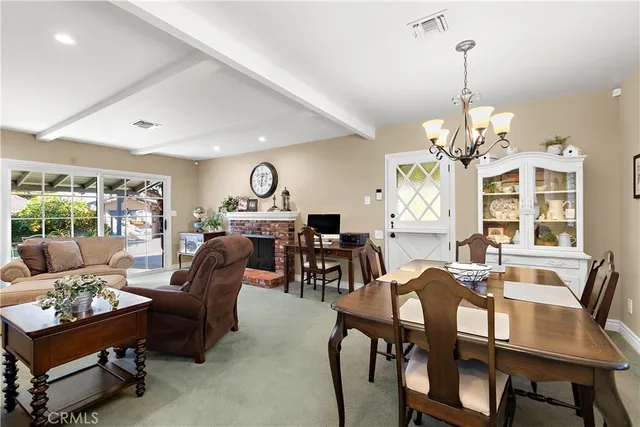a living room with furniture chandelier and a chandelier