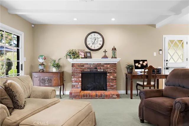 a living room with furniture a clock and a fireplace