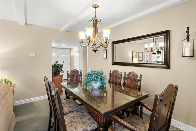 a dining room with furniture and chandelier