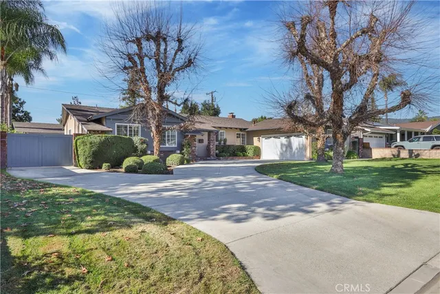 a front view of a house with a yard and shrubs