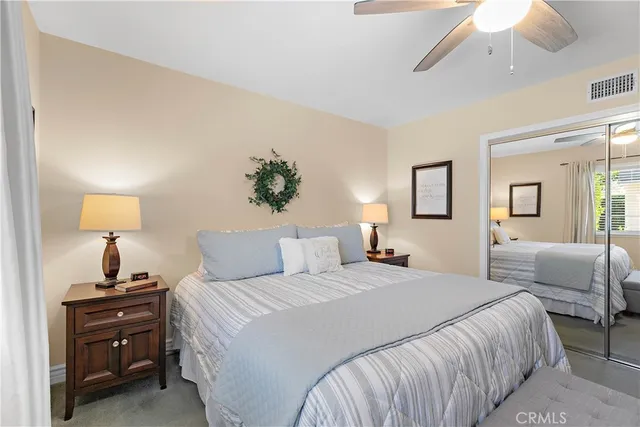 a bedroom with a bed and a lamp