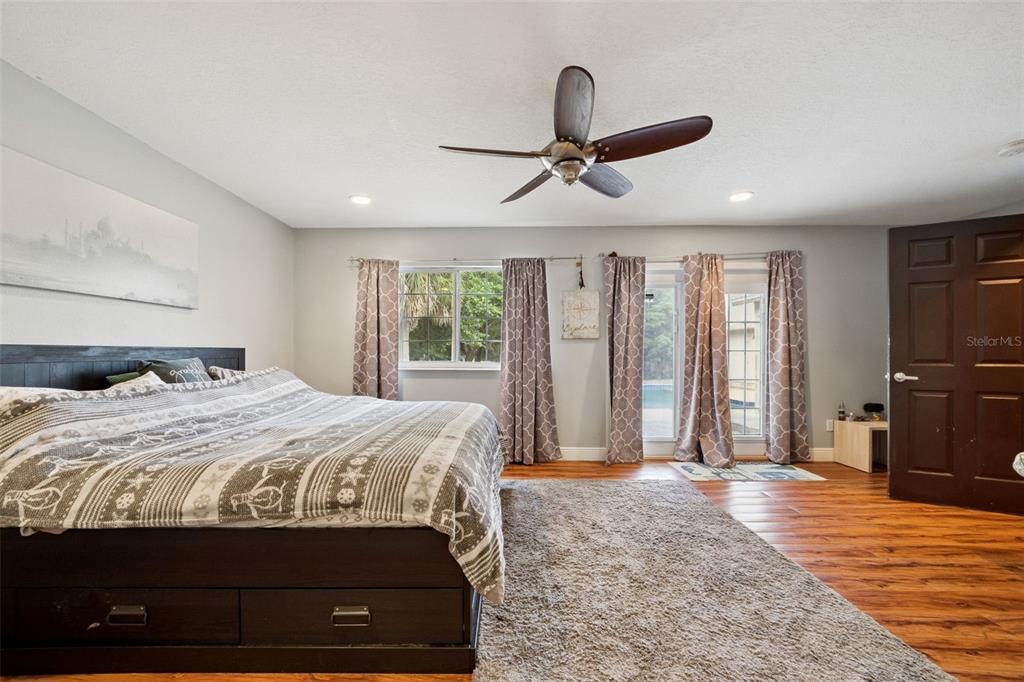 1050 Crystal Bowl Circle Casselberry, FL 32707 - Photo 16 of 64 a bedroom with a bed and large windows