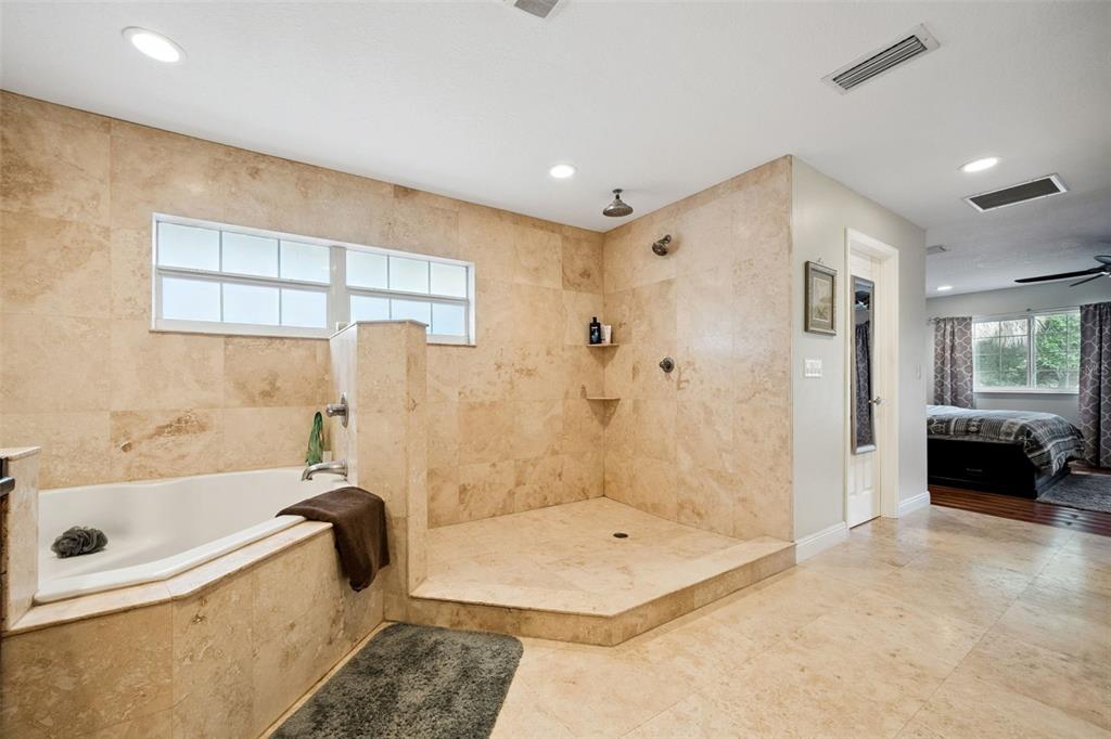 1050 Crystal Bowl Circle Casselberry, FL 32707 - Photo 20 of 64 a bathroom with a tub a sink and a shower