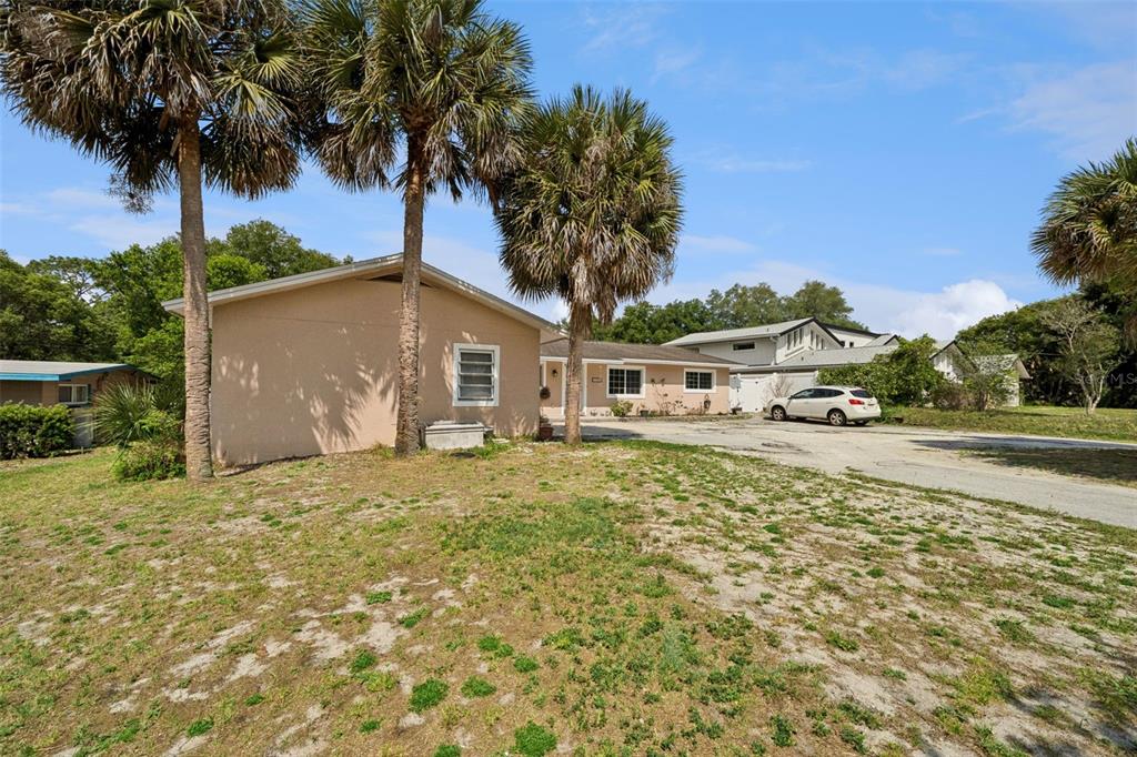 1050 Crystal Bowl Circle Casselberry, FL 32707 - Photo 2 of 64 a front view of a house with a garden and trees