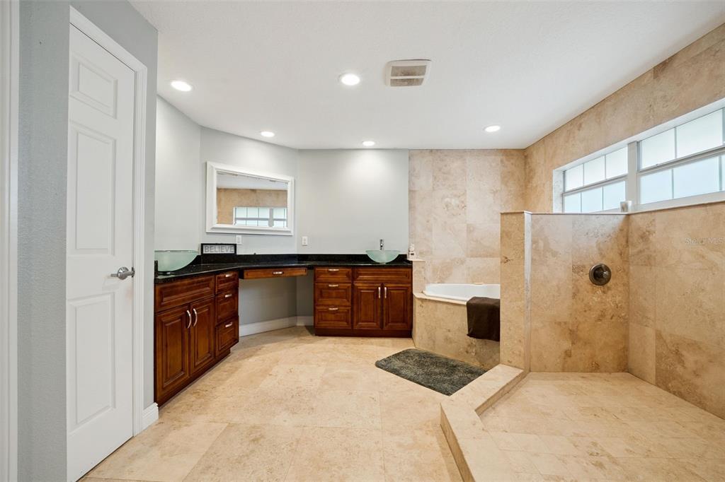 1050 Crystal Bowl Circle Casselberry, FL 32707 - Photo 21 of 64 a large bathroom with a tub sink and a shower
