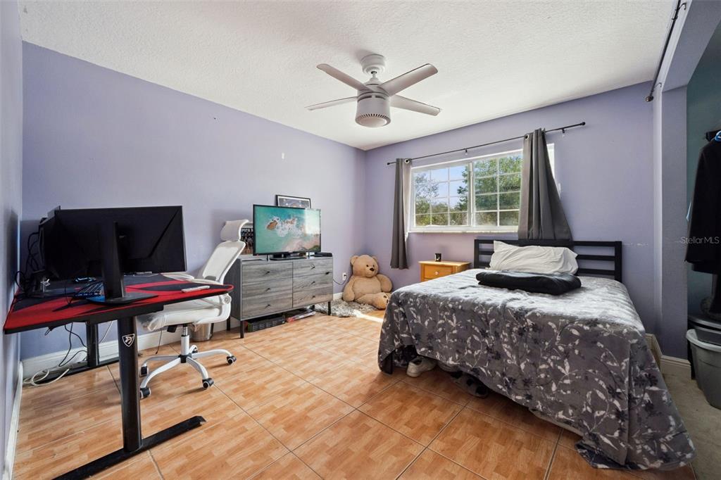 1050 Crystal Bowl Circle Casselberry, FL 32707 - Photo 27 of 64 a bedroom with a bed and a flat screen tv