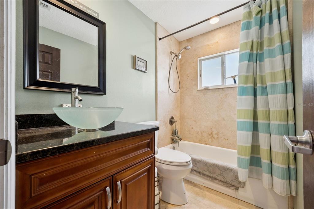 1050 Crystal Bowl Circle Casselberry, FL 32707 - Photo 29 of 64 a bathroom with a granite countertop sink a mirror and a shower