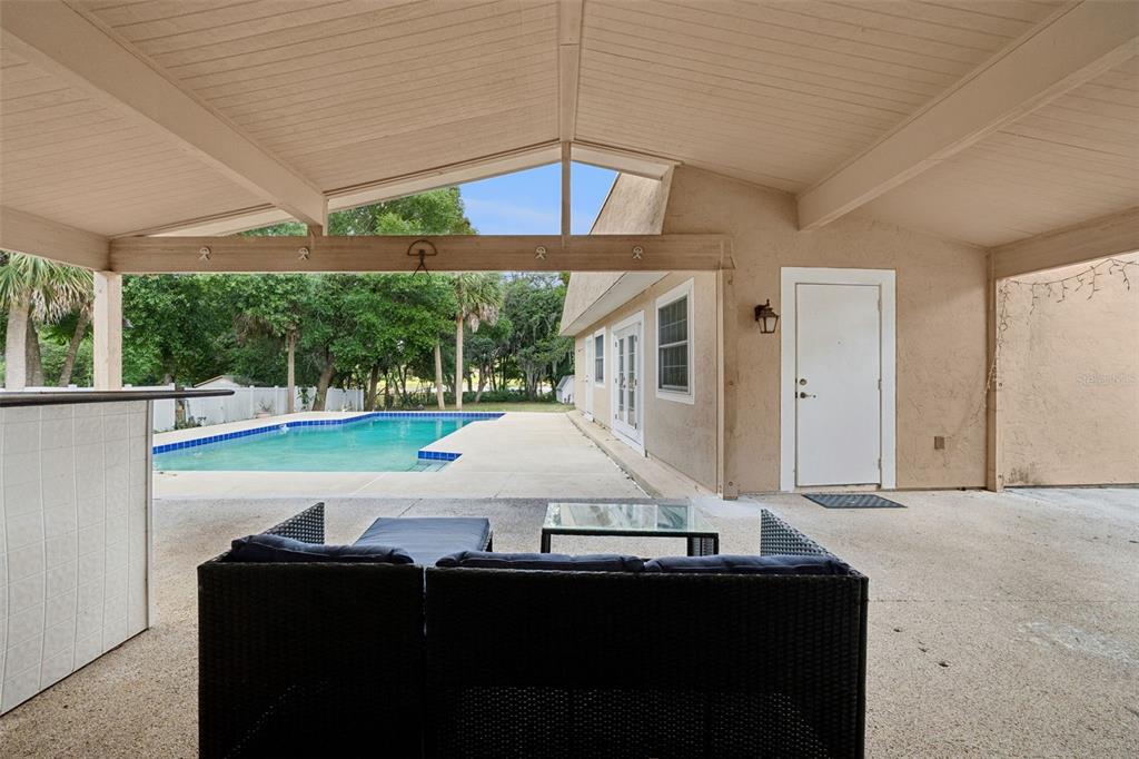 1050 Crystal Bowl Circle Casselberry, FL 32707 - Photo 30 of 64 a view of a patio with a table and chairs under an umbrella