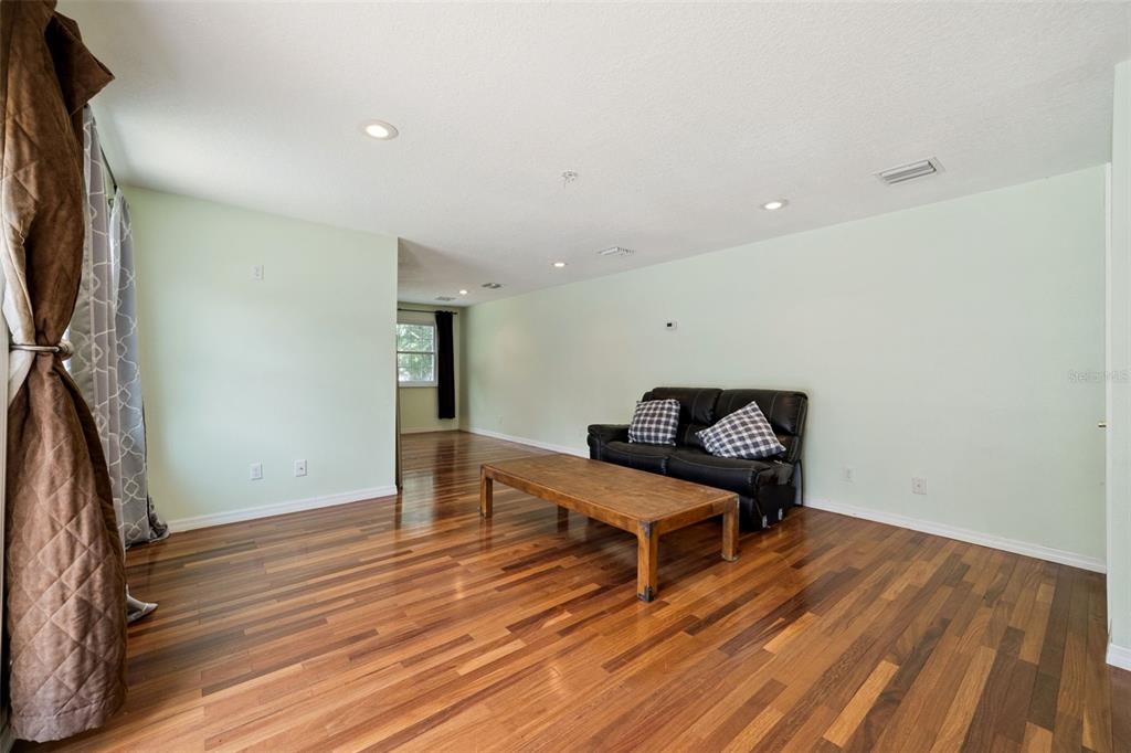 1050 Crystal Bowl Circle Casselberry, FL 32707 - Photo 39 of 64 a room with wooden floor and staircase