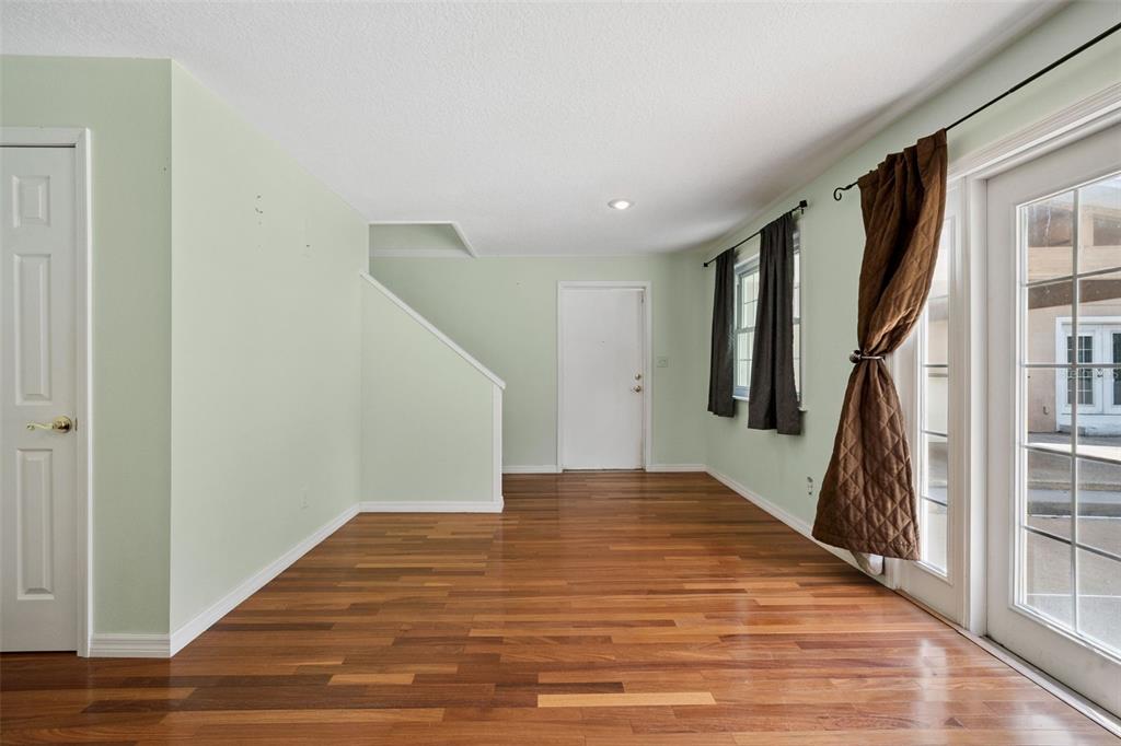 1050 Crystal Bowl Circle Casselberry, FL 32707 - Photo 41 of 64 a view of a hallway with wooden floor and staircase