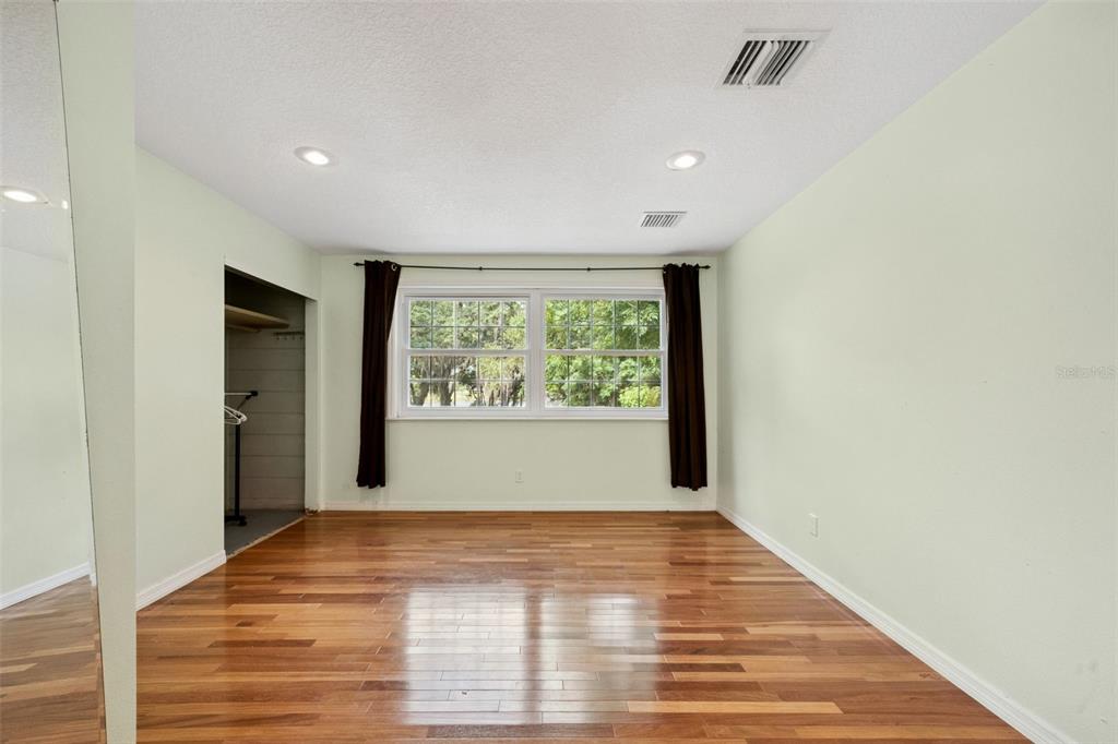 1050 Crystal Bowl Circle Casselberry, FL 32707 - Photo 42 of 64 a view of an empty room with wooden floor and a window