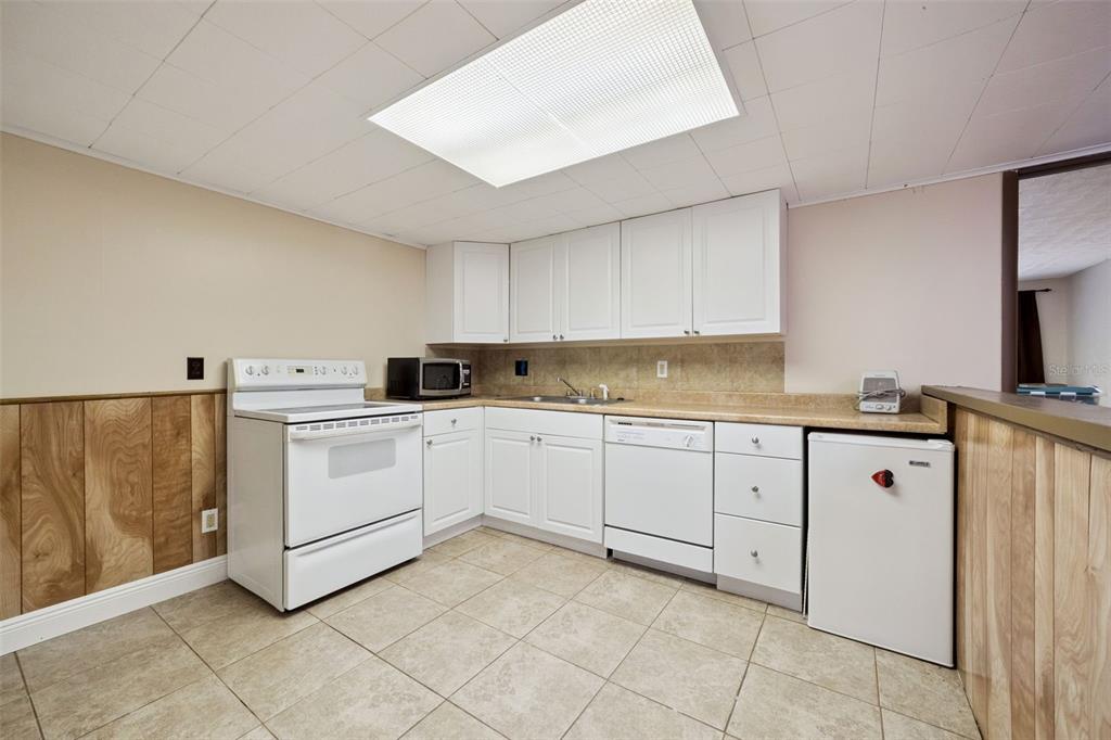 1050 Crystal Bowl Circle Casselberry, FL 32707 - Photo 44 of 64 a kitchen with cabinets and white appliances