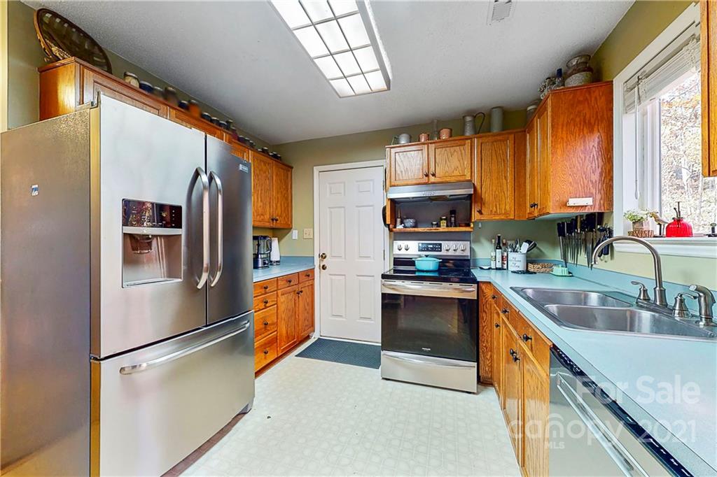 254 Bubbling Well Road Denver, NC 28037 - Photo 14 of 38 a kitchen with stainless steel appliances granite countertop a refrigerator a stove top oven a sink and dishwasher