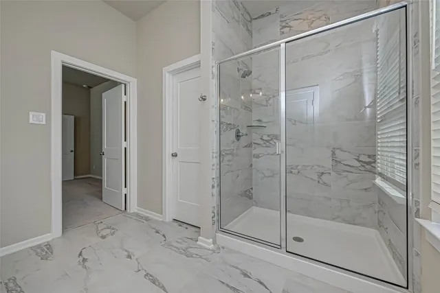 a bathroom with a glass shower door