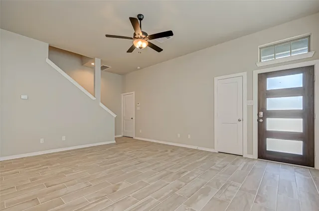 a view of room with window and ceiling fan
